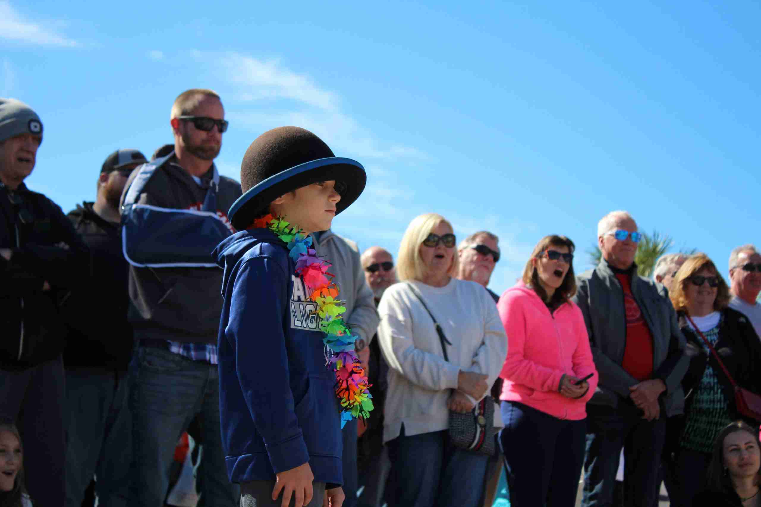 Child Participating In A Magic Show While Adults Enjoy The Performance Child Participating In A Magic Show While Adults Enjoy The Performance